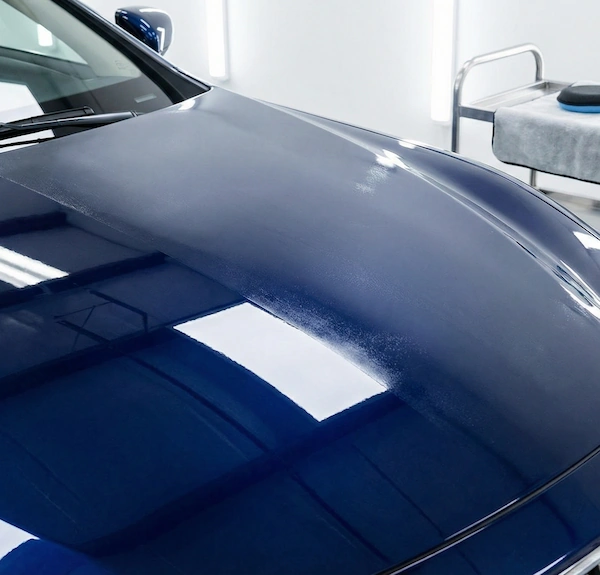 Half-and-half ceramic coating demonstration on a blue car hood by Lustrd Detailing in Sydney.
