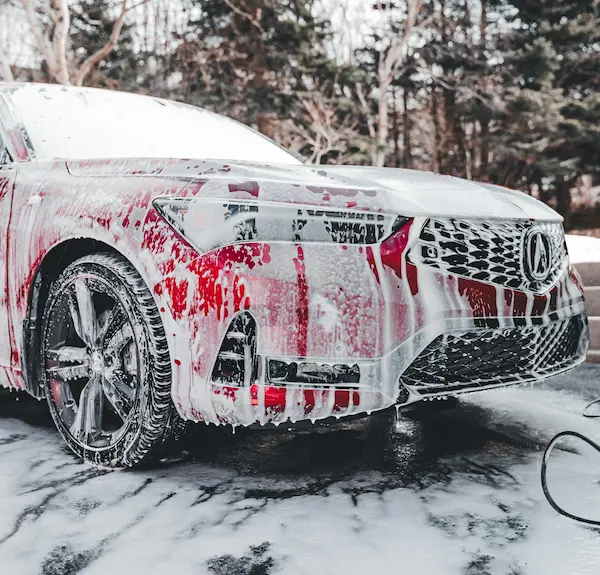 Professional car detailing snow foam wash on a red luxury sedan by Lustrd Detailing in Sydney.