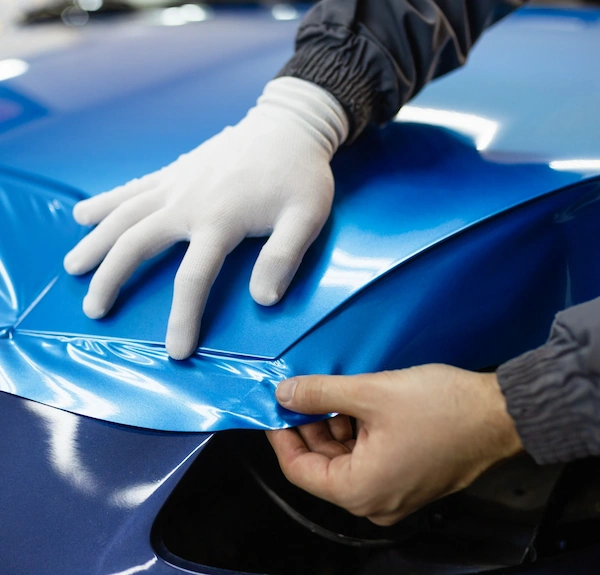 Precision blue metallic vinyl wrap installation on a luxury vehicle by Lustrd Detailing in Sydney.
