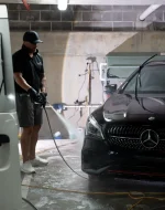 Professional car detailing high-pressure wash on a black Mercedes by Lustrd Detailing in Sydney.