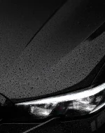 Premium car detailing in Sydney showing hydrophobic water beading on a luxury black BMW hood by Lustrd Detailing.